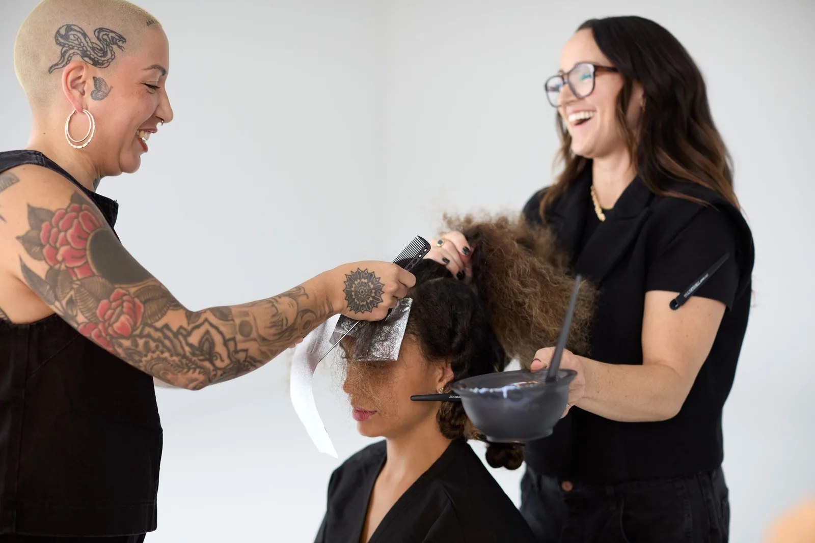 Paul Mitchell Schools alumni and professionals working together in the salon